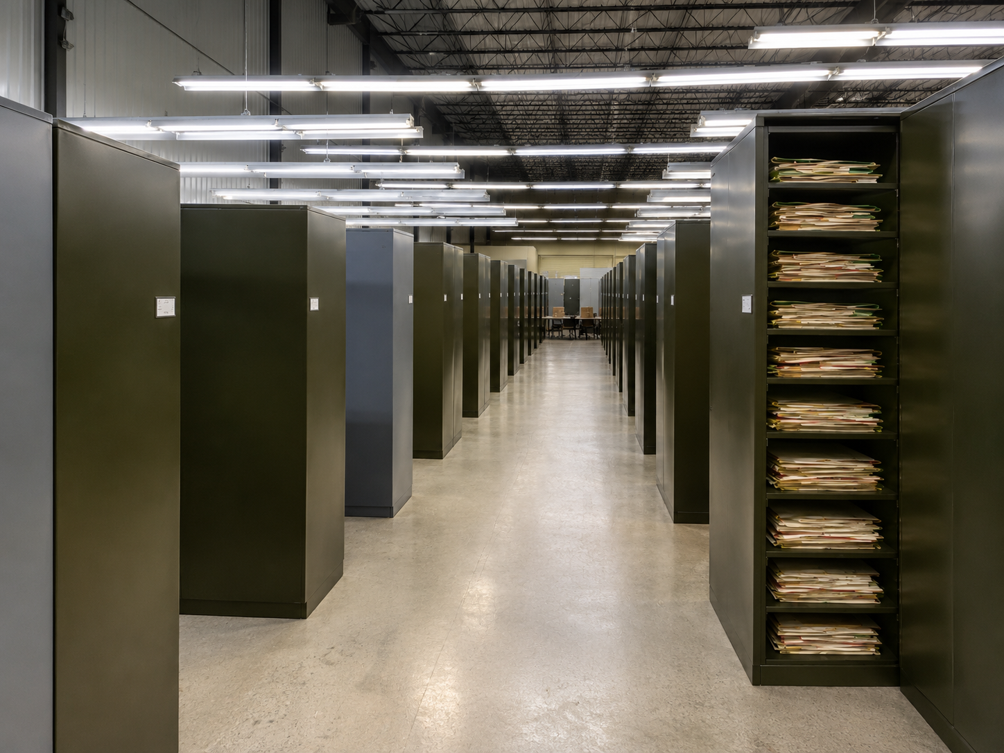 Rows of herbarium cabinets at the S.M. Tracy Herbarium, with one open cabinet showing stacked specimen folders